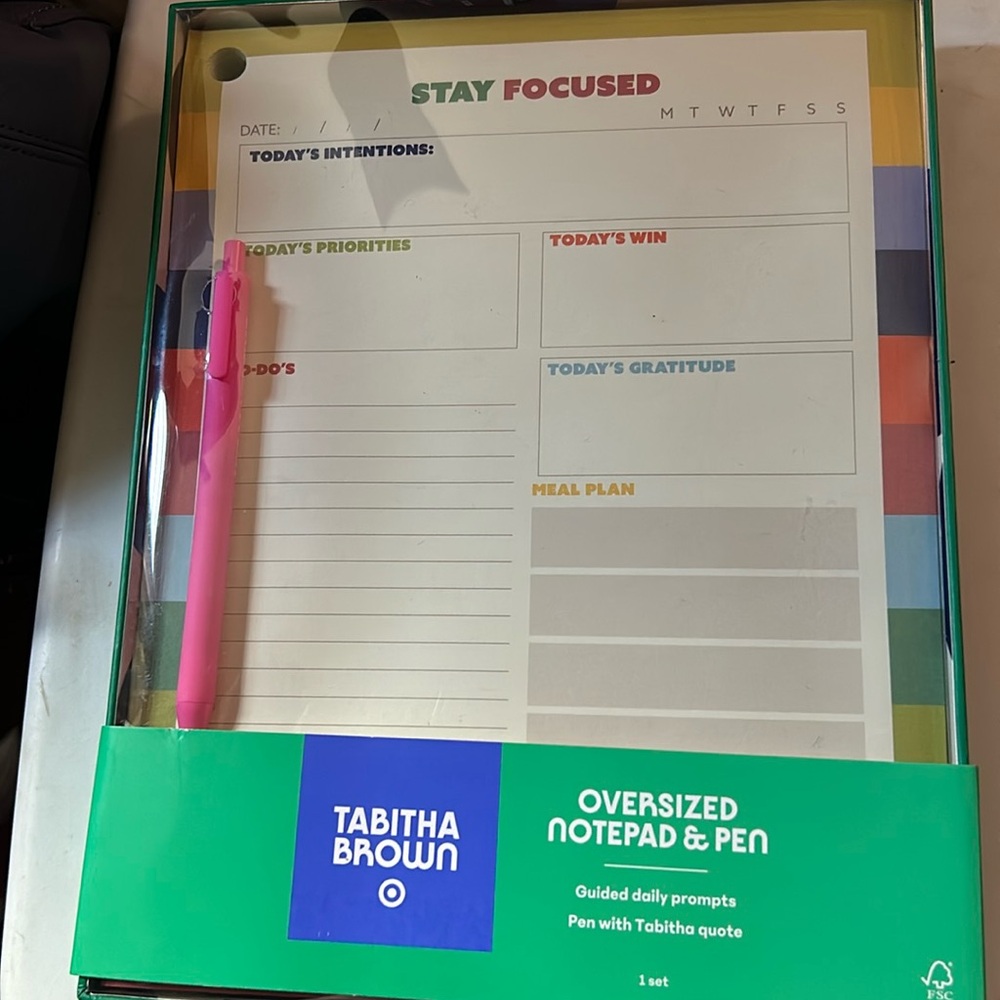 Tabatha Brown, oversized notepad and pen.